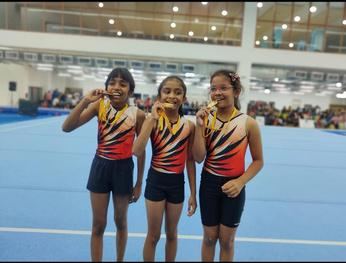 Three Aerial Zone gymnasts showing their medals