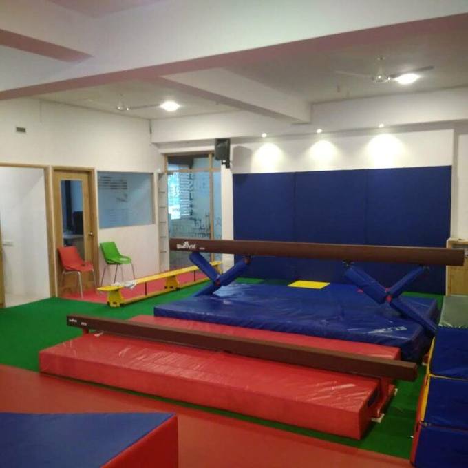Balance beams and crash mats in the Aerial Zone gym