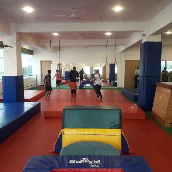The main training floor at Aerial Zone with vaulting blocks and rings